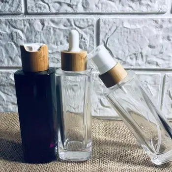 Продажба на едро, обичай бутилки за лосион от прозрачно стъкло с логото, с капак от естествен бамбук, флакон за парфюм, празна опаковка за пипети за грижа за кожата